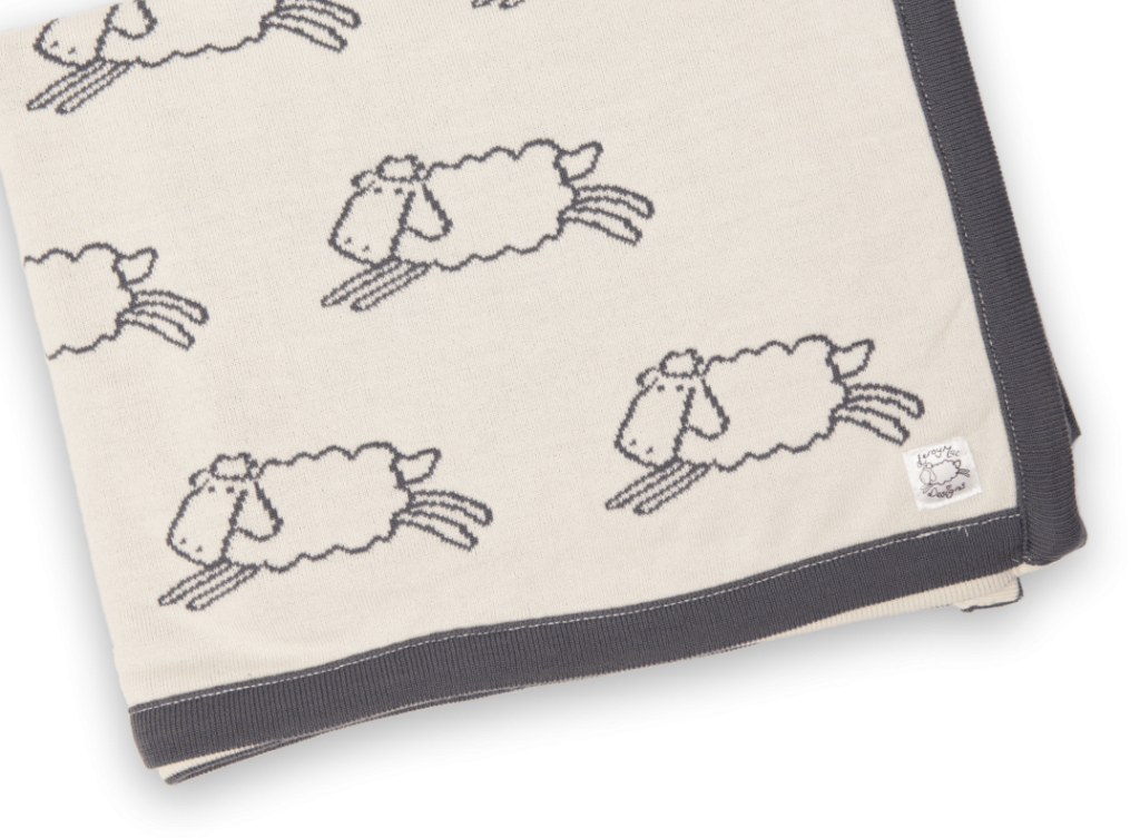 Cream blanket with grey sheep pattern