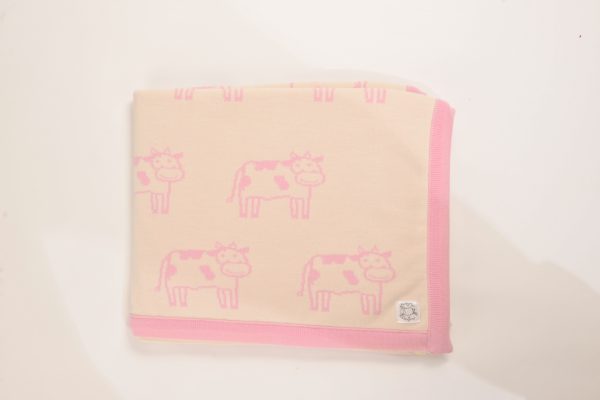 Cream blanket with pink edging and cow pattern