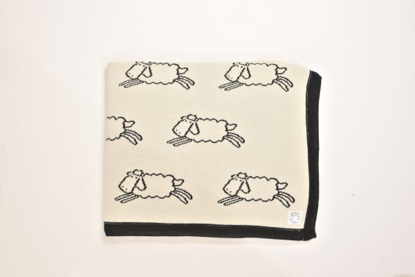 Cream blanket with black sheep pattern