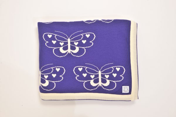 Purple blanket with cream edging and cream butterfly pattern
