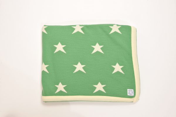 Green blanket with cream edging and stars