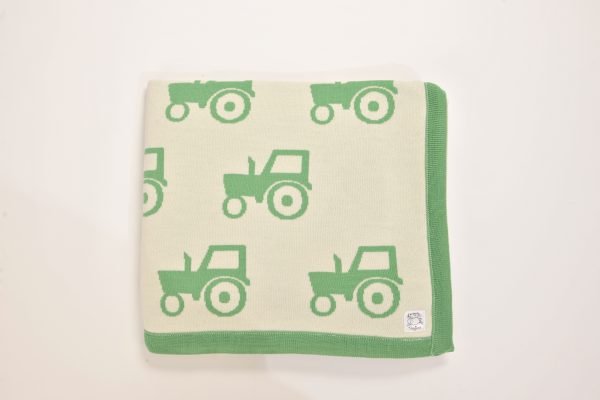 Cream blanket with green tractor pattern and edging