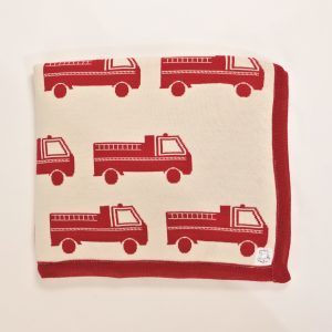Cream blanket with red firetruck pattern