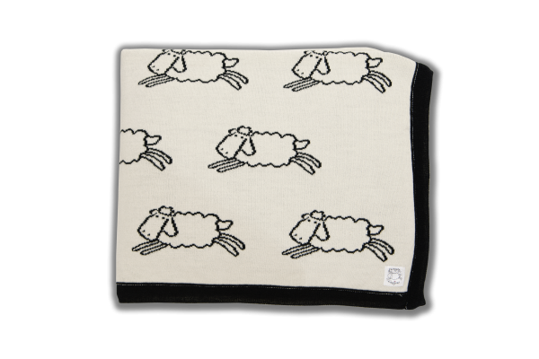 Cream blanket with black edging and black sheep pattern