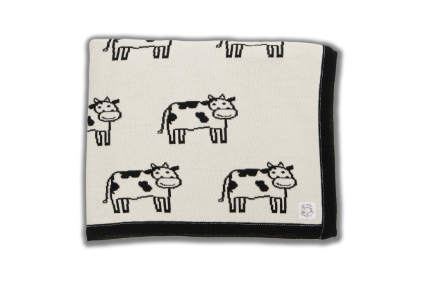 Cream blanket with black edging and black cow pattern