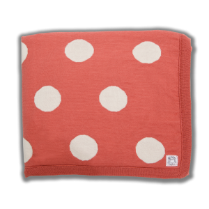 Salmon coloured blanket with cream spots
